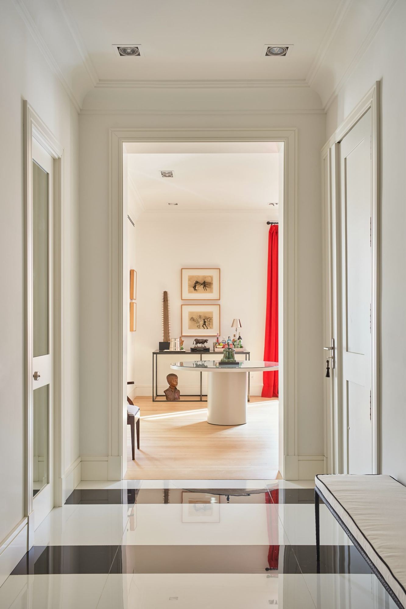 Entrance hall from ceiling to black and white marble floor, looking through to the living room